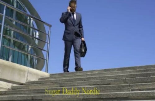 Mees ülikonnas räägib telefoniga, kui ta trepist alla läheb, esindades "Splenda Daddy".