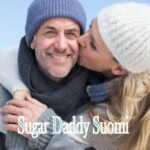 Sugar Daddy mies hymyilee hattu ja sugar baby suutelee ja halaa häntä lumessa